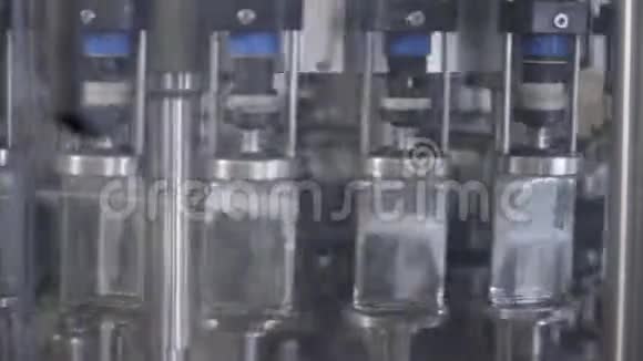 在酒厂的玻璃瓶里溢出伏特加工厂玻璃瓶灌装机酒精饮料溢漏视频的预览图