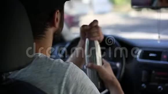 年轻人开车从钢制热瓶里喝水视频的预览图