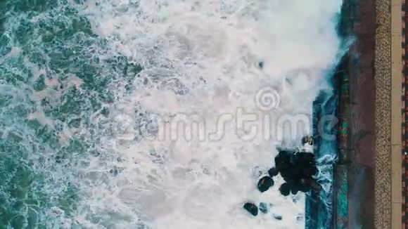 海波撞击海滩岩石的高空俯视图视频的预览图
