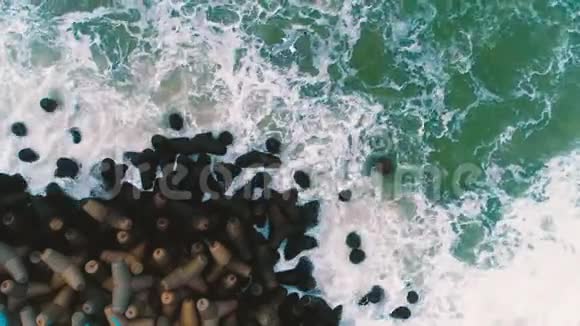 海波撞击海滩岩石的高空俯视图视频的预览图