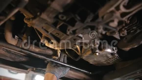 汽车修理店汽车的下面的部分男人从污垢中抹去细节视频的预览图