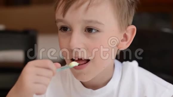 可爱的男孩在咖啡馆吃冰淇淋快乐的孩子一边吃冰淇淋一边微笑失去孩子的婴儿牙齿视频的预览图