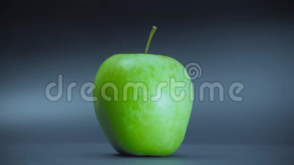 真实的绿色苹果在黑色背景上旋转视频的预览图