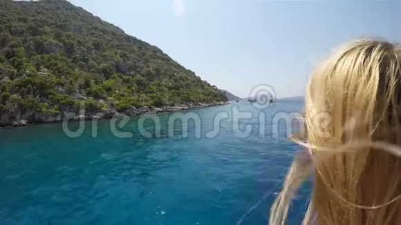 一个女孩从一艘漂浮的海船甲板上欣赏大海和风景视频的预览图
