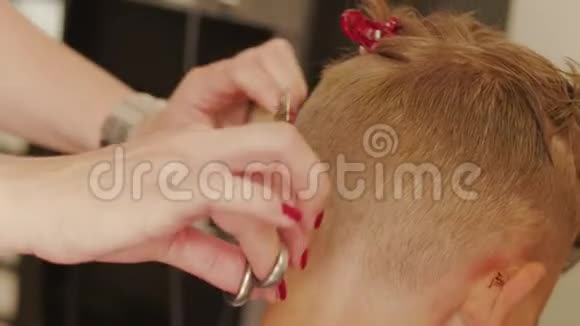 理发师用剪刀剪青少年的头发视频的预览图