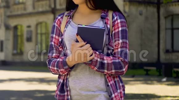 悲伤的女学生独自站着拿着笔记本没有朋友孤独视频的预览图