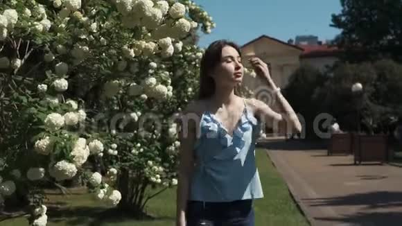 美丽的自由深爱的黑发姑娘白天在夏园散步视频的预览图