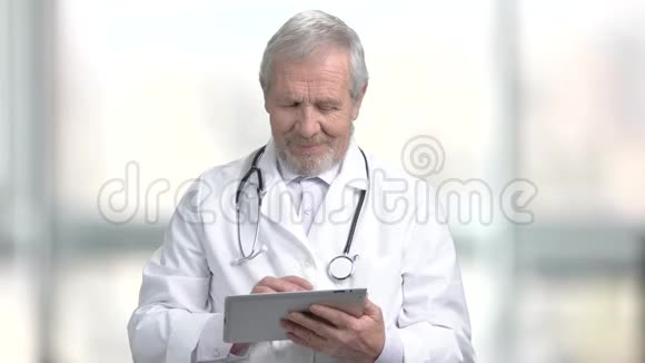 微笑老年医生与PC片视频的预览图