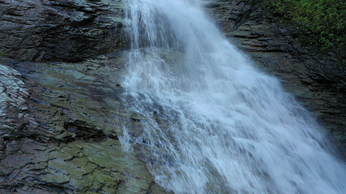 瀑布顺着石头飞驰而下高清实拍视频素材视频的预览图