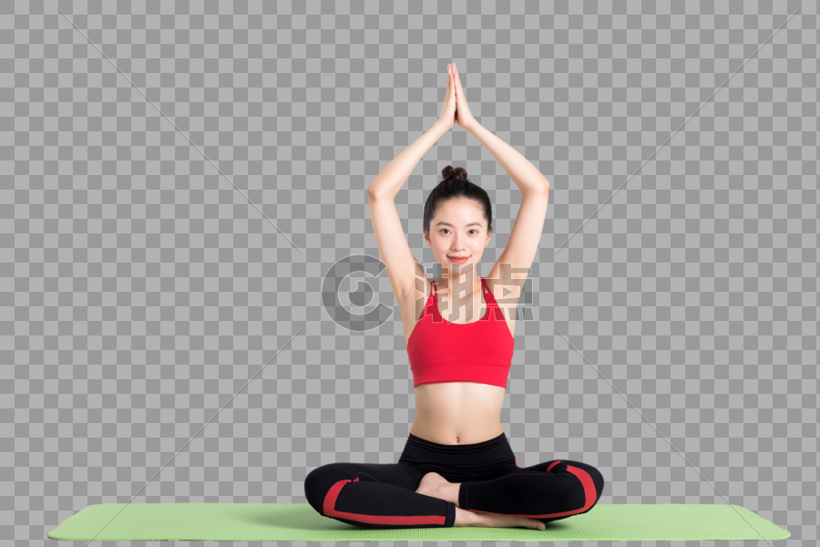 坐在瑜伽垫上做瑜伽动作的女性图片素材免费下载