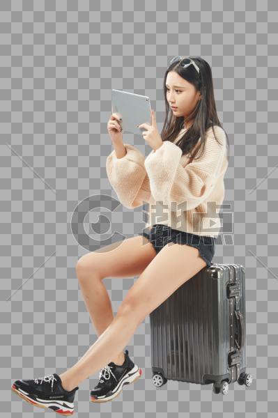 年轻女孩坐在行李箱上玩平板电脑图片素材免费下载