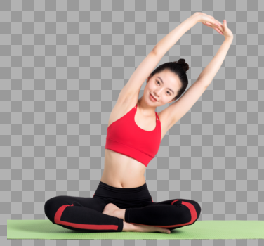 坐在瑜伽垫上做瑜伽动作的女性图片素材免费下载