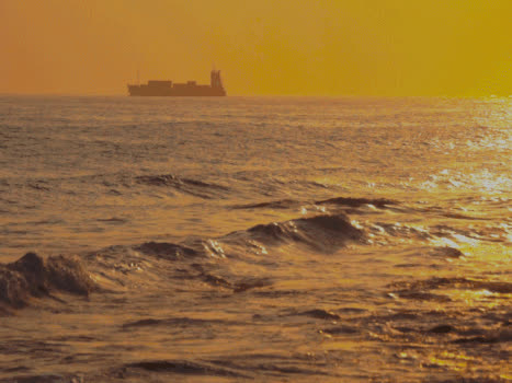 黄昏下的海上货轮和灯塔GIF图片素材免费下载