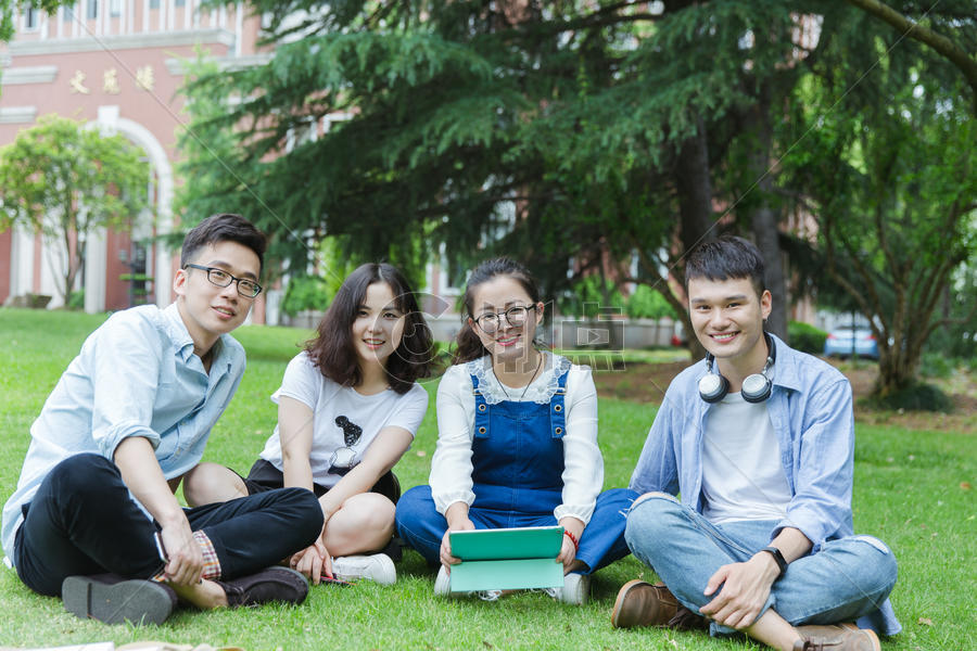 男女大学生们坐草地上聊天休息图片素材免费下载