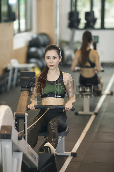 女性在健身房使用划船机练习力量图片素材免费下载