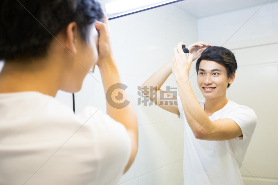 年轻男子在浴室整理头发图片素材免费下载