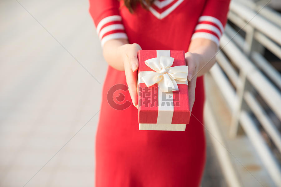 手拿礼物盒的红衣女性图片素材免费下载
