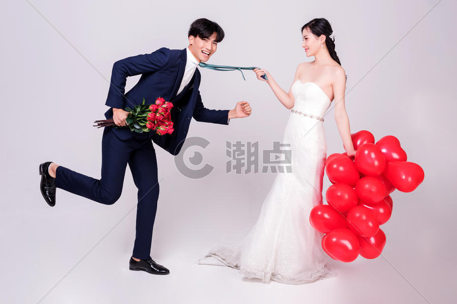 情侣婚纱手持爱心气球互相打闹动作图片素材免费下载