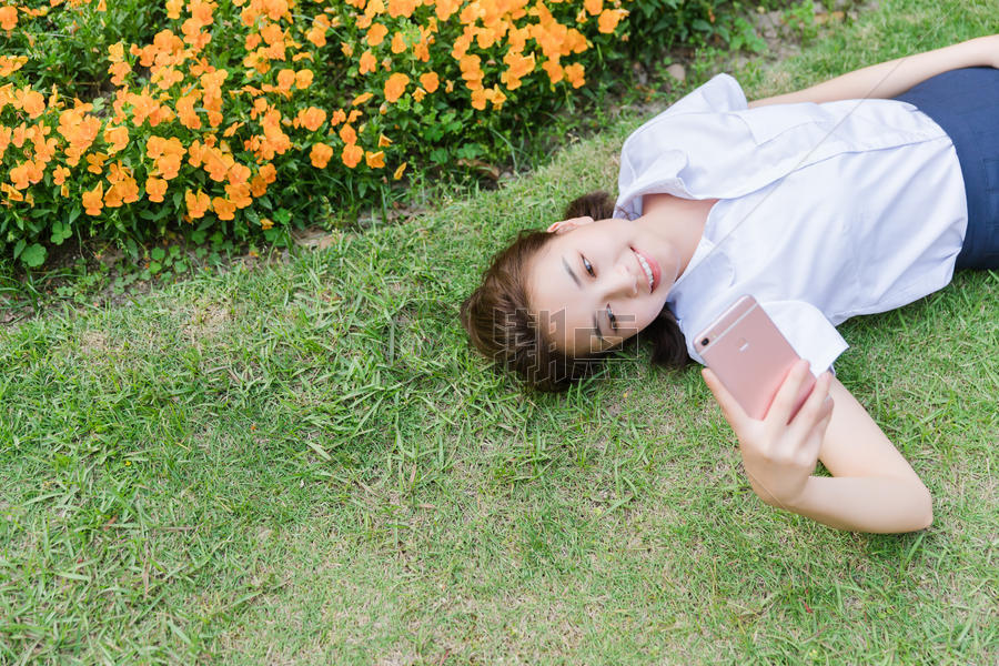 校园写真女生躺在草地上图片素材免费下载