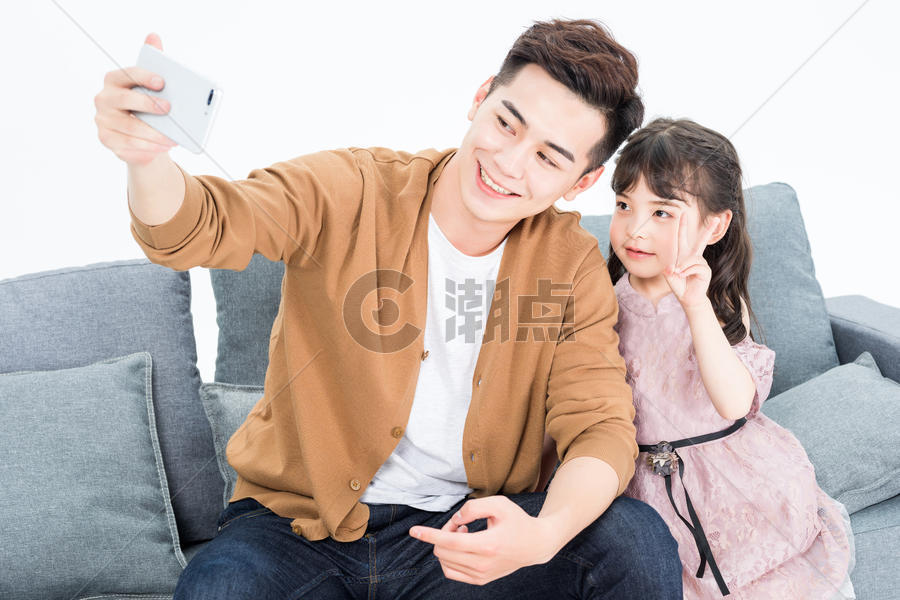 年轻爸爸和女儿在客厅沙发拍照自拍图片素材免费下载