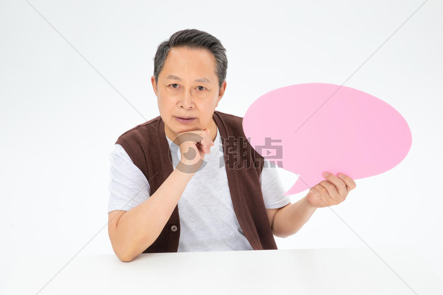 手拿粉色对话气泡框的老年人图片素材免费下载