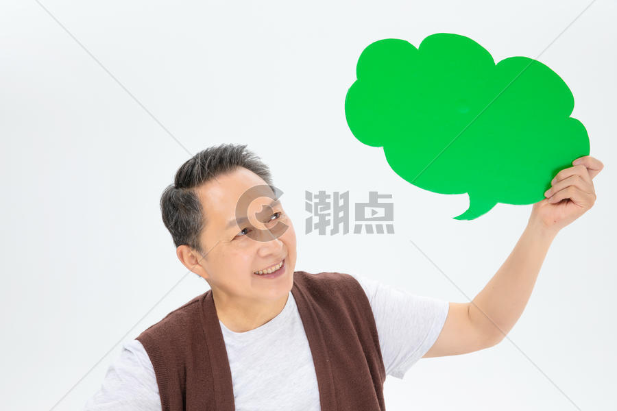 手拿绿色气泡框的老年人图片素材免费下载