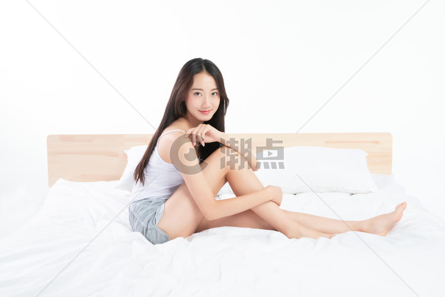 年轻女孩坐在床上图片素材免费下载