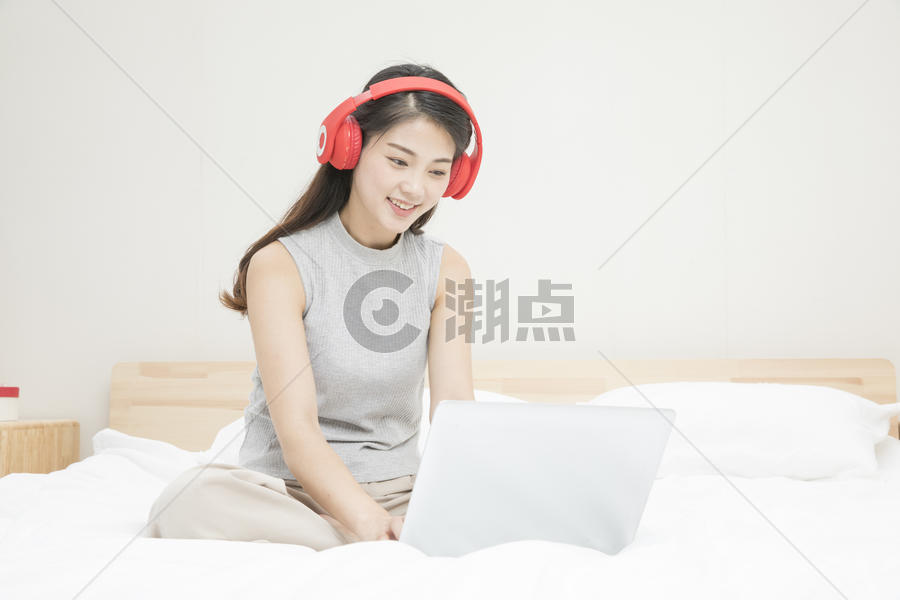 带耳机玩电脑的女孩图片素材免费下载