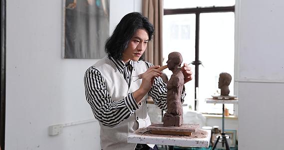 年轻男艺术家专注雕刻视频的预览图