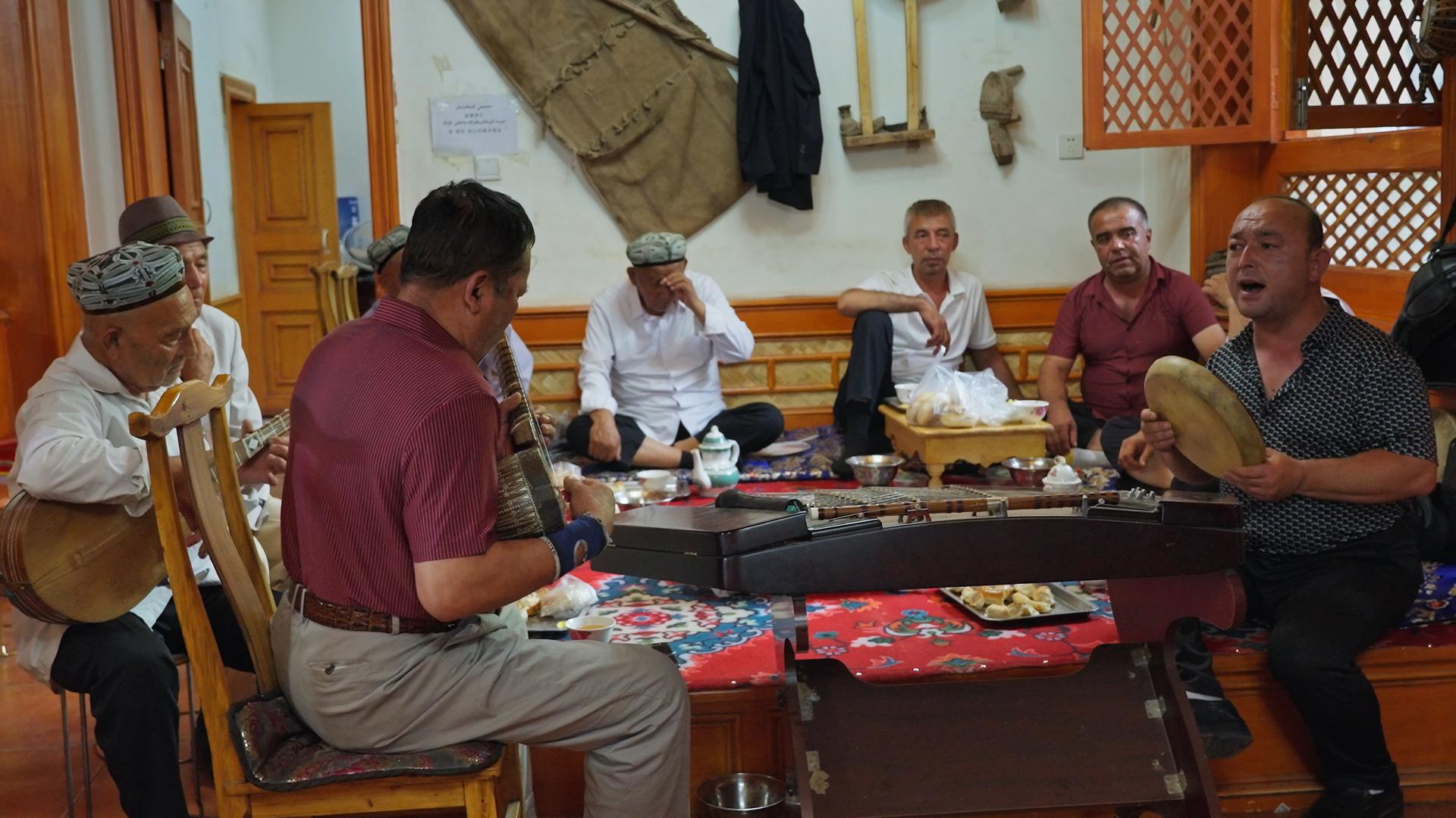在新疆维吾尔族茶馆里演奏乐器的人的预览图