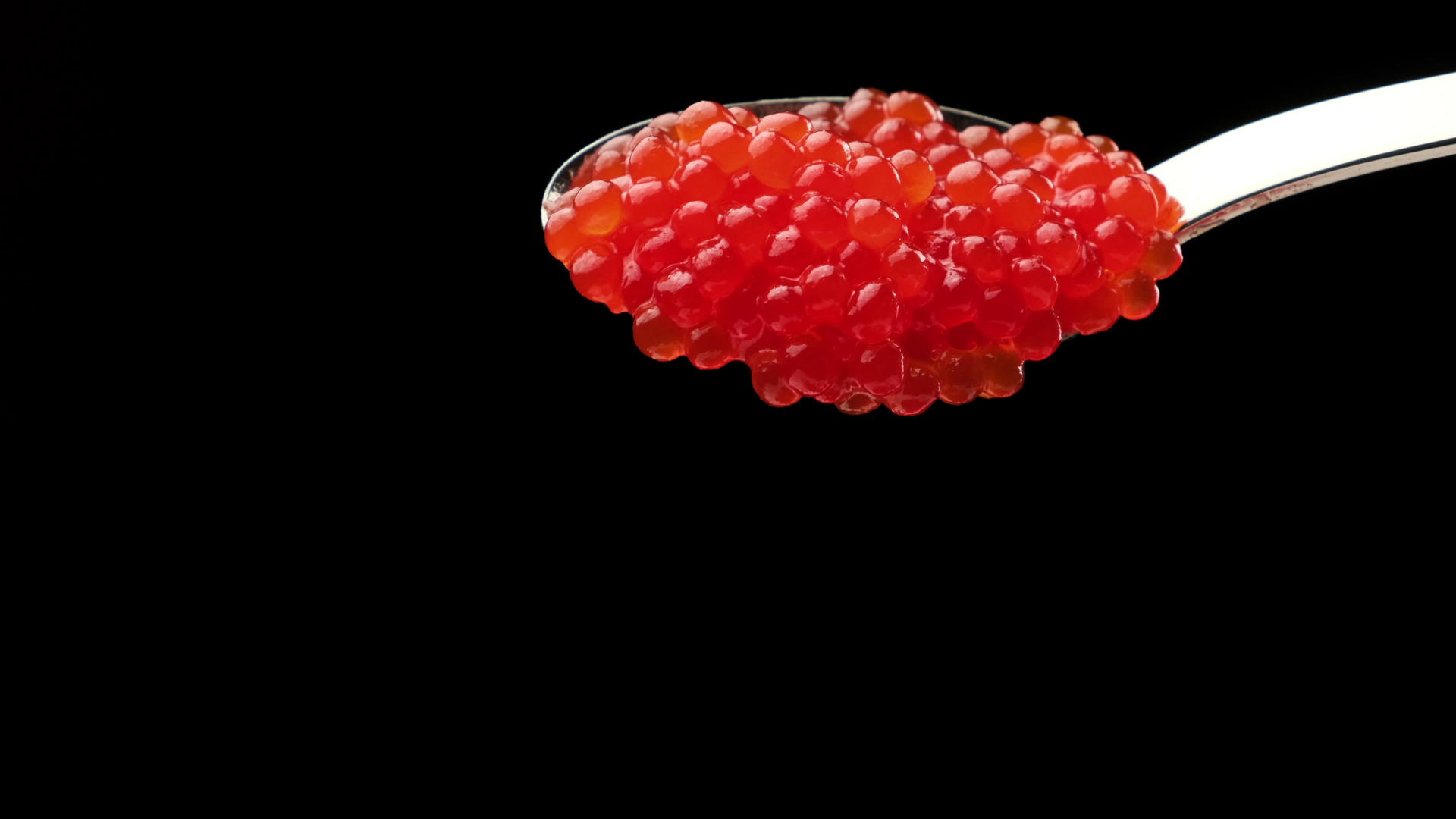 黑色背景中金属勺中的红鲑鱼鱼子酱美味健康视频的预览图