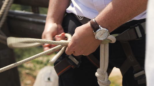 穿西装的专业极端专业登山者为大攀登准备安全绳索视频的预览图