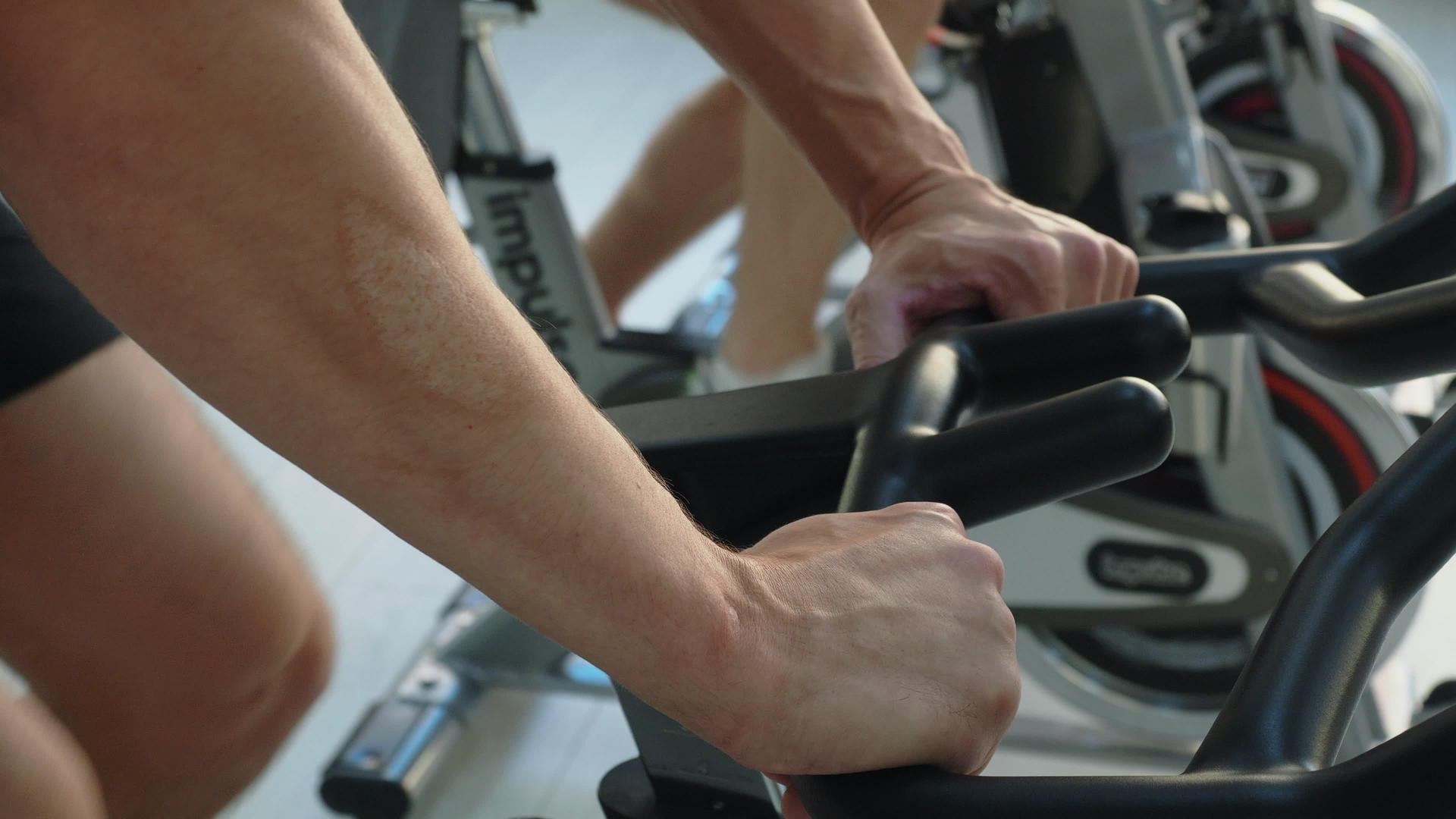 男性在健身工作室骑自行车的男性在健身房骑自行车视频的预览图