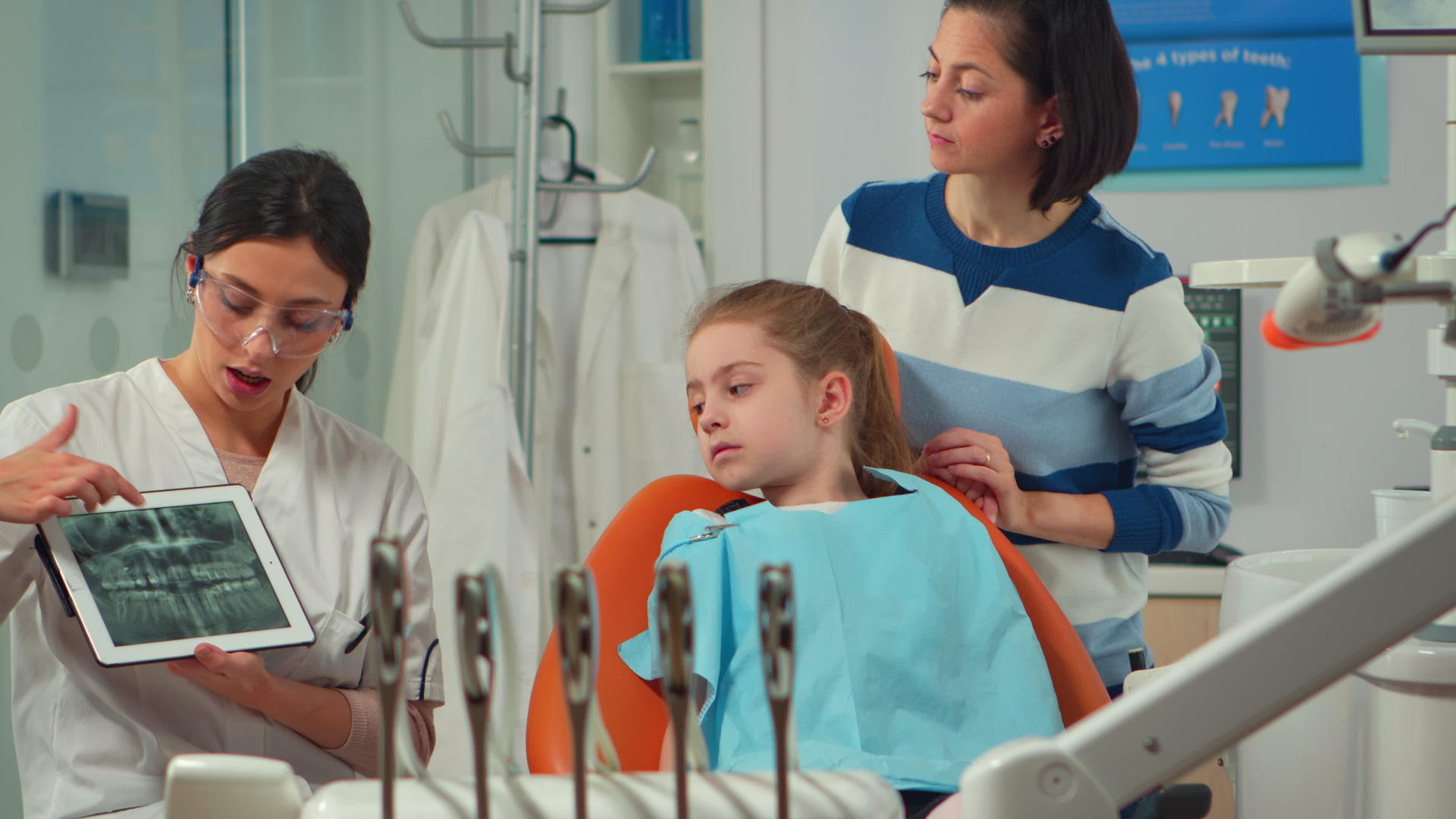 牙医向牙科诊所的病人展示了X光牙齿视频的预览图
