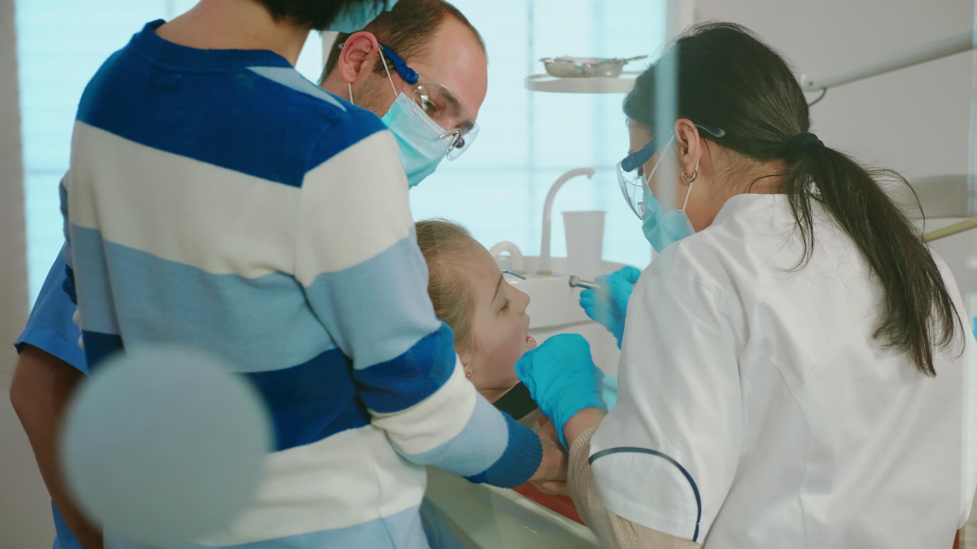戴手套和口罩的牙医去除牙齿、腐烂的牙齿、钻牙和牙齿视频的预览图