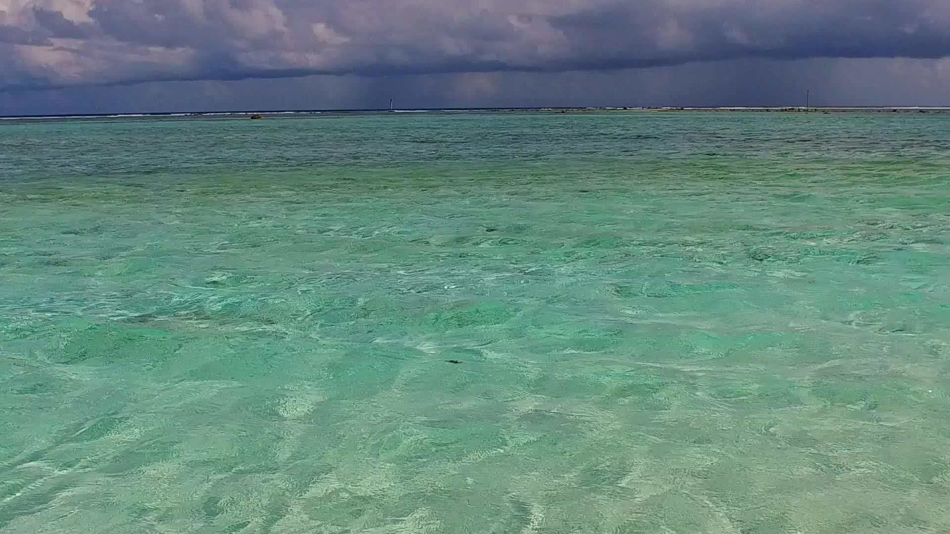 度假胜地附近的绿松石海和明亮的沙滩背景视频的预览图