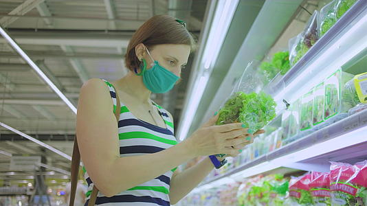 30名戴着保护面具的妇女在超市寻找杂货和面具视频的预览图