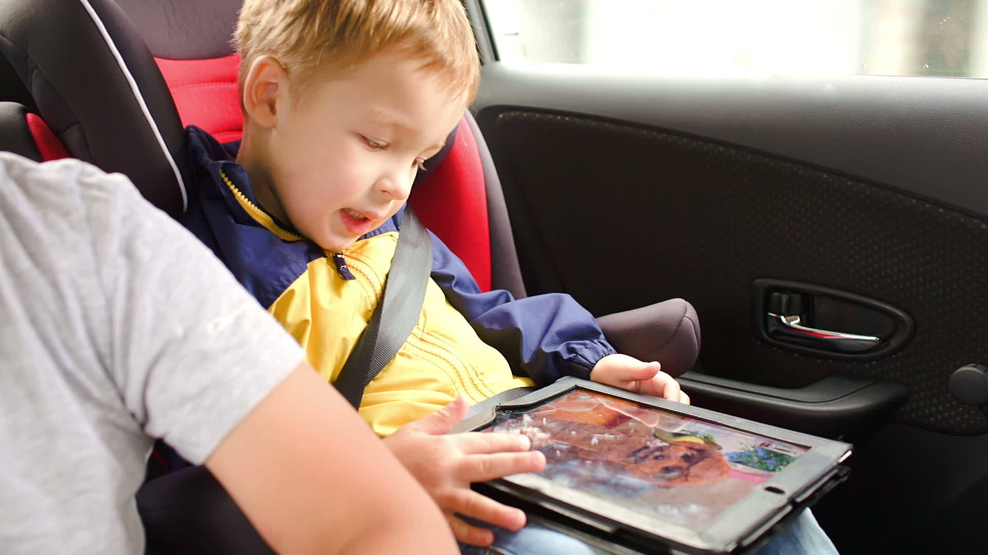 汽车旅行时快乐的男孩在床垫上玩游戏视频的预览图