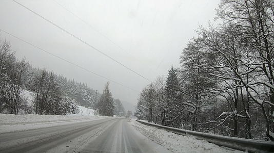 汽车在冬天的路上行驶在暴风雪的第一视角视频的预览图