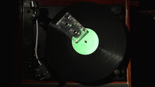带磁带的磁带盒和乙烯基绿色圆盘的复古概念转盘视频的预览图