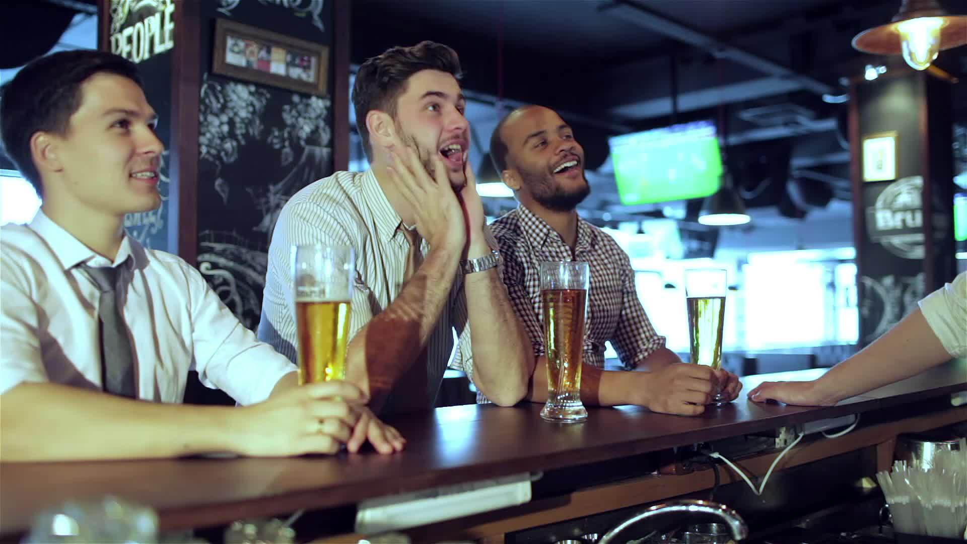 男性球迷在电视上看足球和喝啤酒视频的预览图