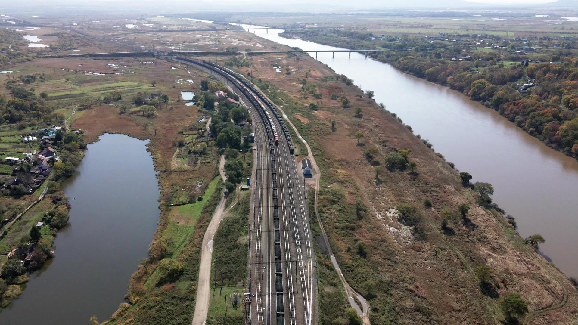 从上面看摄像机飞过一条大河沿岸的铁路视频的预览图