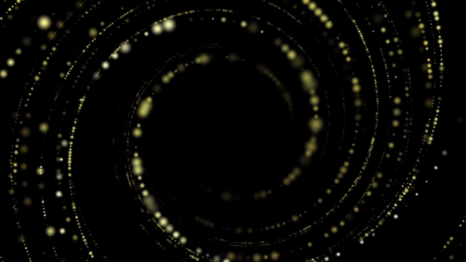 黑色背景空间中缓慢的黄色圆形颗粒环形运动视频的预览图
