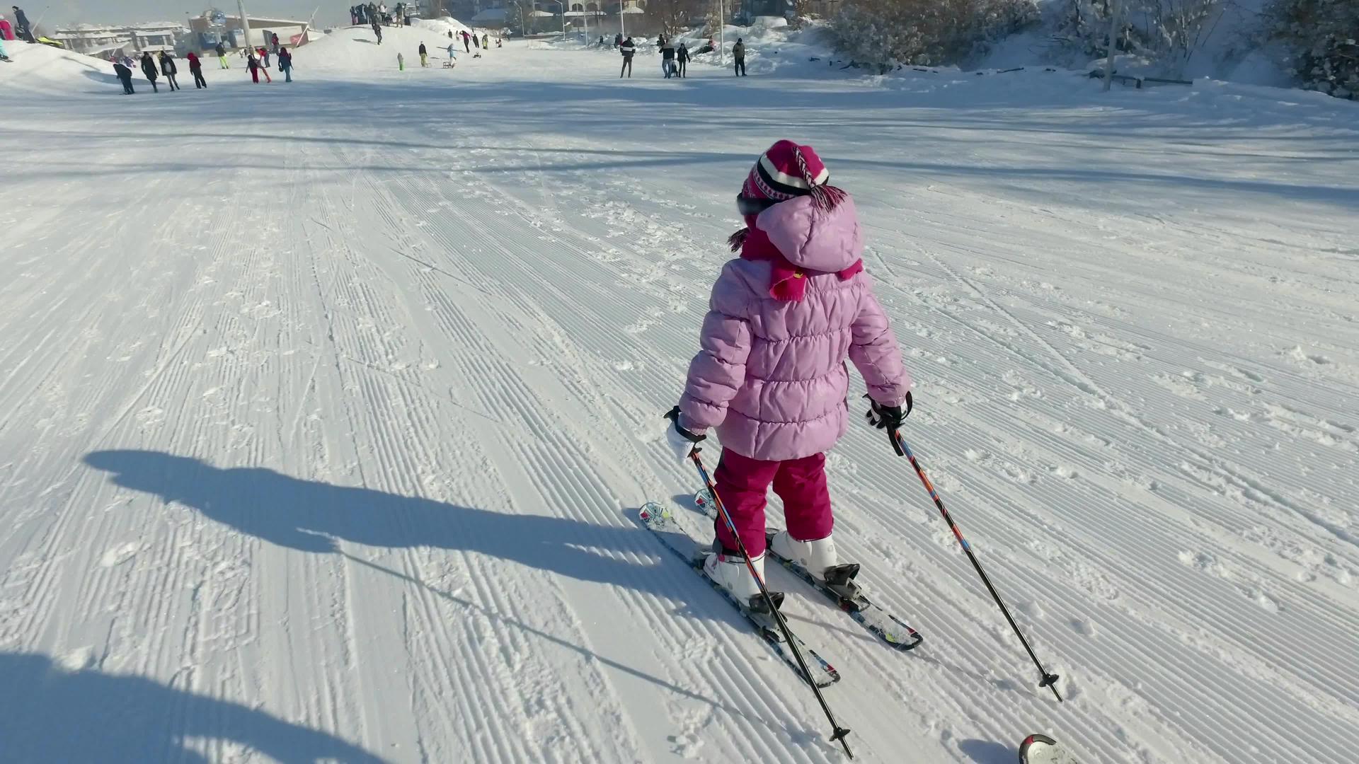 小女孩在冬天的设备下滑雪视频的预览图