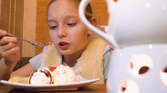 十几岁的女孩在餐桌上吃冰淇淋甜点视频的预览图
