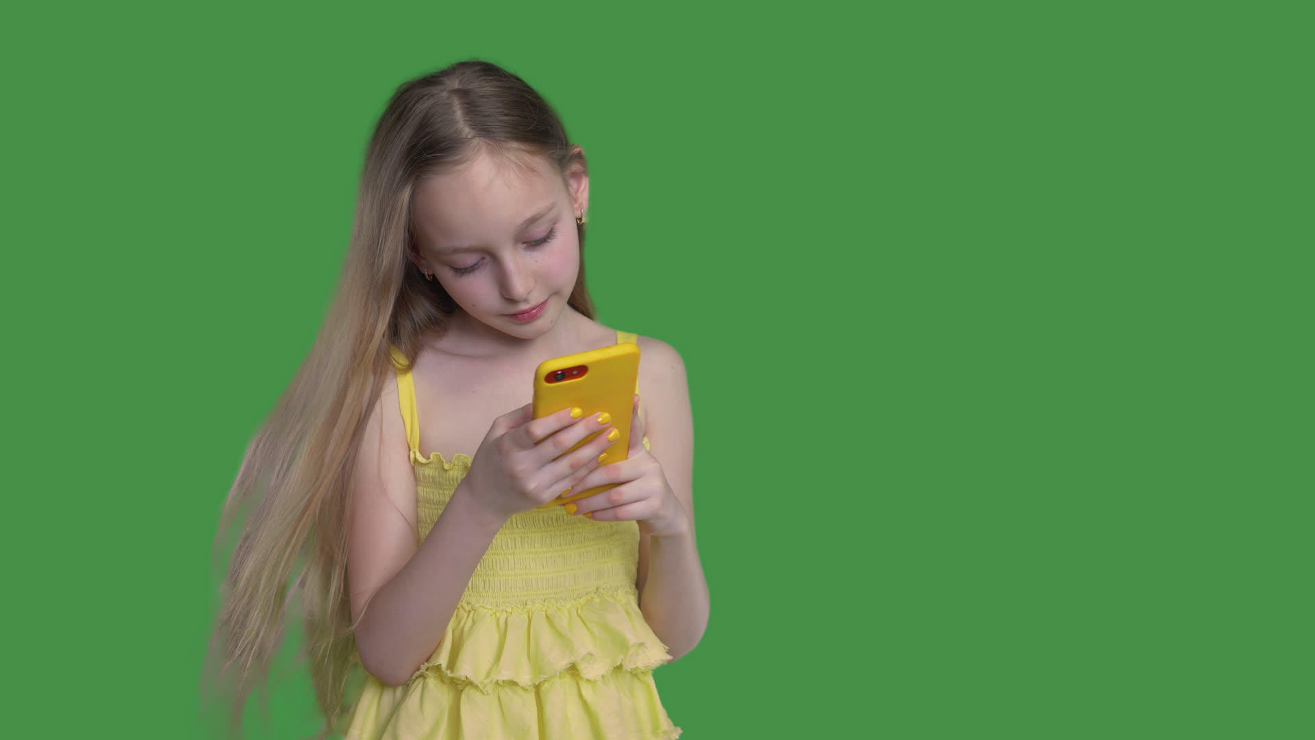 十几岁的女孩在透明的绿色背景下使用手机视频的预览图