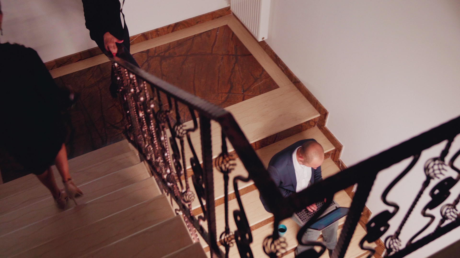 忙碌的商人坐在楼梯上工作的顶部视图视频的预览图