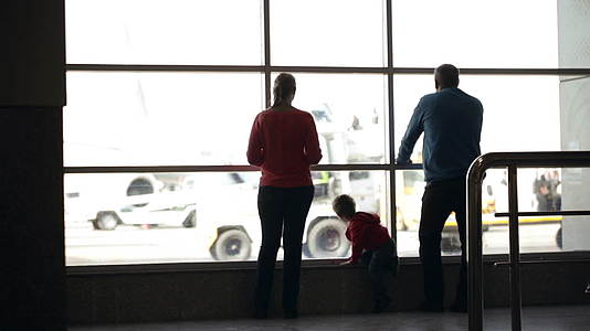 在机场观看飞机的年轻家庭视频的预览图