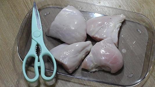 用锋利的肉剪刀把鸡胸肉切成碎片视频的预览图