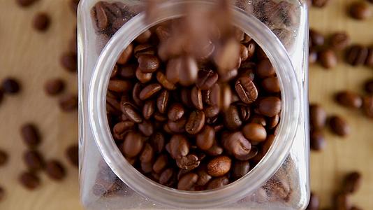 新鲜咖啡豆掉进罐子里视频的预览图